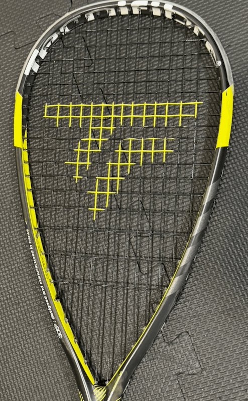 Squash racquet with a yellow logo printed on black strings
